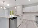 Charming kitchen features stainless steel appliances, white cabinets, stone countertops, and a modern faucet at 16253 Sw 29Th Court Rd, Ocala, FL 34473