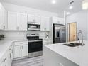 Bright kitchen with white cabinetry, stainless steel appliances, and quartz countertops at 16253 Sw 29Th Court Rd, Ocala, FL 34473