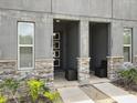 Inviting double-door entryway with stone accents and neutral-toned facade at 1632 Tropical Palms Circle, Kissimmee, FL 34747