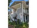 Condo exterior featuring stairs to upper units with lush greenery at 2216 Stonington Ave # 2216, Orlando, FL 32817