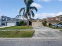 Suburban home showcasing mature landscaping, two-car garage, neutral paint, and well-manicured lawn at 2226 Newt St, Orlando, FL 32837