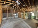 Open-concept interior showcasing exposed ceiling beams, concrete floors, and potential for customization at 2226 Newt St, Orlando, FL 32837