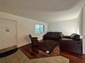 Inviting living room with hardwood floors and neutral paint at 2349 Oak Park Way # 107, Orlando, FL 32822