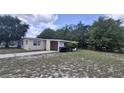 Single story home featuring neutral paint, an attached carport, and a concrete driveway at 2422 Kingsland Ave, Orlando, FL 32808