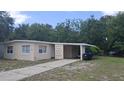 Single story home featuring neutral paint, an attached carport, and a concrete driveway at 2422 Kingsland Ave, Orlando, FL 32808
