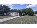 Single story home featuring neutral paint, an attached carport, and a concrete driveway at 2422 Kingsland Ave, Orlando, FL 32808