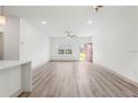 Bright living room with light wood floors and a red front door at 2593 Sw 153Rd Ln, Ocala, FL 34473