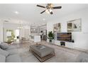 Open-concept living room with modern furnishings, light wood floors, and plenty of natural light at 2593 Sw 153Rd Ln, Ocala, FL 34473
