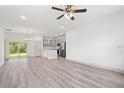 Open-concept living space featuring a modern kitchen, stainless steel appliances, and sliding glass doors to the backyard at 2593 Sw 153Rd Ln, Ocala, FL 34473