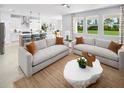 Stylish living room featuring modern sofas, a unique coffee table, and natural light streaming through windows at 2681 Ginseng Ivy St, Apopka, FL 32703