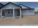 Newly built home with a two-car garage, covered porch, and light-colored exterior at 30112 Misty Pines Rd, Mount Dora, FL 32757