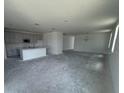 Open-concept living area with kitchen, dining space, and plenty of natural light from large windows at 30112 Misty Pines Rd, Mount Dora, FL 32757