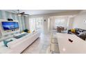 Inviting living room featuring a comfy sofa, TV, and sliding glass doors for indoor-outdoor living at 3150 Paradox Cir # 102, Kissimmee, FL 34746