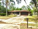 Well-maintained single-story brick home with a two-car garage and a long driveway at 3152 Clewiston St, Deltona, FL 32738