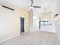 Bright living room boasts tile flooring, a ceiling fan, and neutral walls that create a spacious and airy atmosphere at 3208 W Tower Ct, Kissimmee, FL 34741