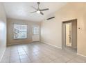 Open-concept living space featuring tile floors, a ceiling fan, and a seamless transition to other areas of the home at 3208 W Tower Ct, Kissimmee, FL 34741