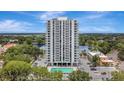 Exterior building view with a pool, parking lot, and beautiful lake and skyline at 400 E Colonial Dr # 1202, Orlando, FL 32803