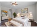 Staged bedroom with neutral colors, hardwood floors, large windows, and stylish decor, creating a relaxing atmosphere at 405 E Freesia Ct, Deland, FL 32724