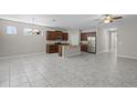 Open floor plan showcasing the dining area, and kitchen with stainless steel appliances and a center island at 405 E Freesia Ct, Deland, FL 32724