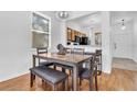 A dining room features a dining table with chairs, benches, and overhead lighting at 4143 Calabria Ave, Davenport, FL 33897