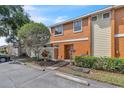 Inviting townhouse showcasing vibrant landscaping, fresh exterior paint and convenient parking spaces at 46 Silver Falls Cir, Kissimmee, FL 34743