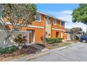 Attractive townhouse featuring vibrant exterior, manicured landscaping, and close resident parking at 46 Silver Falls Cir, Kissimmee, FL 34743