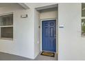 Close-up of unit 105's blue front door, featuring a 