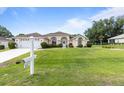 Inviting single-Gathering house with a manicured lawn and attached two-car garage in a residential area at 5076 Nw 21St Loop, Ocala, FL 34482