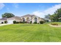 Spacious single-Gathering home with a well-kept lawn and mature landscaping on a sunny day at 5076 Nw 21St Loop, Ocala, FL 34482
