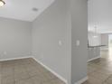 Open concept living space with neutral walls, tile floors, and natural light at 523 Tortugas St, Haines City, FL 33844
