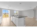 Open-concept kitchen island features a sink, dishwasher, and plenty of room for entertaining at 531 Tortugas St, Haines City, FL 33844