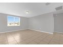 Bright living room features tile floors and a large window with beautiful views at 531 Tortugas St, Haines City, FL 33844