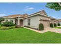 Charming home featuring a two-car garage, neutral paint, brick driveway, manicured lawn, and mature landscaping at 578 Newhall Ln, Debary, FL 32713