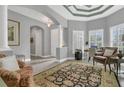 Neutral living room featuring an elegant ceiling, recessed lights, tile floor, columns, and view to front entry at 578 Newhall Ln, Debary, FL 32713