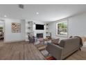 Comfortable living room with built-in shelving around a fireplace and a large window at 7813 Delphia St, Orlando, FL 32807