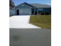 Inviting home with a freshly painted driveway, well-maintained lawn, and attractive curb appeal at 8187 Sw 60Th Ter, Ocala, FL 34476