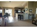 Open-concept living space with bar seating, stainless steel appliances, and natural light at 8187 Sw 60Th Ter, Ocala, FL 34476