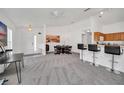 Open living area with neutral carpet, white walls, dining area, and breakfast bar at 941 Clear Creek Cir, Clermont, FL 34714