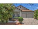 Charming home features a well-manicured lawn, neutral paint, shutters, and an attached two-car garage at 9836 Lake District Ln, Orlando, FL 32832