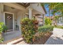 Inviting porch features decorative plants, a welcome mat, and classic columns at 9836 Lake District Ln, Orlando, FL 32832