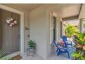 Inviting porch features decorative plants, a welcome mat, classic columns and outdoor seating at 9836 Lake District Ln, Orlando, FL 32832