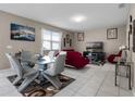 Open living room features tile floors and comfortable seating arrangement at 1165 Stratton Ave, Groveland, FL 34736