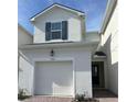 Charming two-story home featuring a one car garage and a welcoming front entrance at 1190 Seaside Mist Trl, Kissimmee, FL 34747