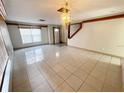 Bright living area showcasing tiled floors, a large window, and an inviting entryway for comfortable living at 13046 Prairie Meadows Dr, Orlando, FL 32837