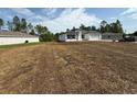 An exterior view of a one-story home that needs to be landscaped at 13265 Sw 85Th Cir, Ocala, FL 34473