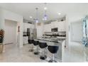 Modern kitchen featuring an island with a black marble countertop and stainless steel appliances at 1396 Riley Cir, Deland, FL 32724