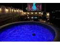 Outdoor space featuring a hot tub and entertaining space with a projector screen at 14 Fir Trail Way, Ocala, FL 34472
