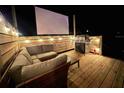 Outdoor deck features a grill, movie screen and comfortable seating for entertainment at 14 Fir Trail Way, Ocala, FL 34472