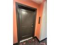 Unit 3636's secure and private front door offering modern lock features and a dark brown trim at 14501 Grove Resort Ave # 3636, Winter Garden, FL 34787