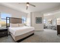 Spacious bedroom suite with large windows and serene views and a seating area at 14501 Grove Resort Ave # 3636, Winter Garden, FL 34787